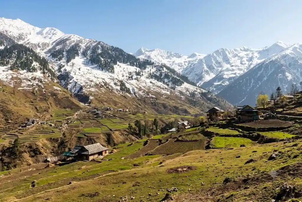 Manali in March with snow on higher slopes and the lower valley thawing